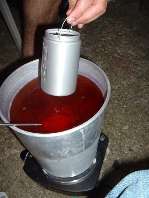 Dunking the annodized shaker into the purple dye.