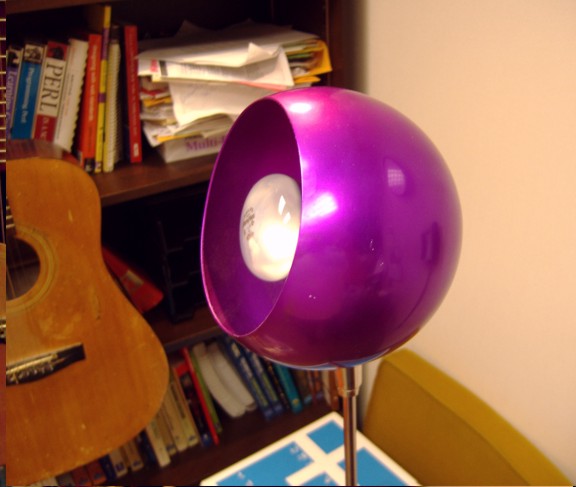 A round floor lamp, annodized purple.