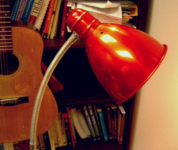 Image of a red, anodized aluminum floor lamp.