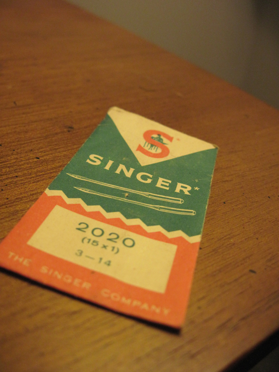 A vintage envelope for  Singer needles. The package reads "Singer / 2020 / (15 x 1) / 3-14 / THE SINGER COMPANY."