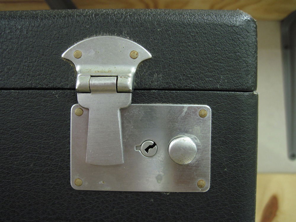 A close-up of the latch before restoration. The rivets are slightly rusty.