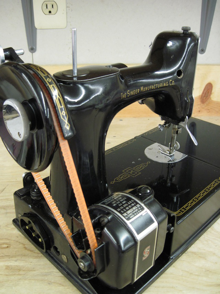 A view of the machine from the motor end, showing the orange toothed replacement belt.