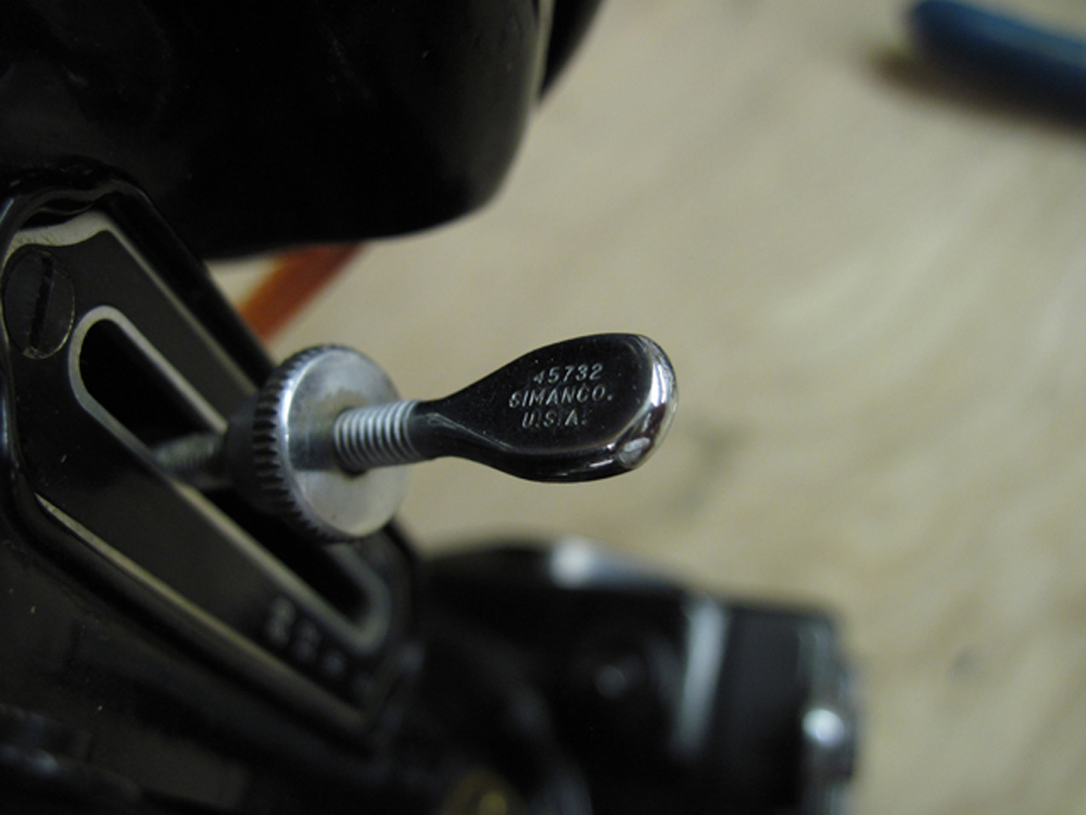 A closeup of the stich length lever. It is stamped "54732 Simanco. U.S.A."