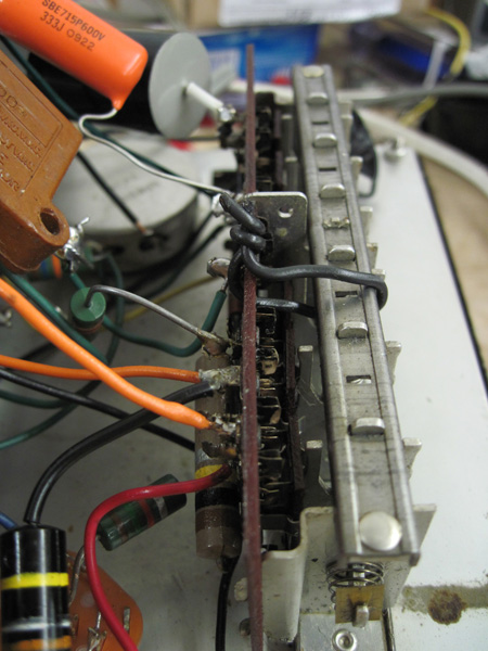 The phenolic terminal board for the selector switch has been reinforced with a short length of copper wire.