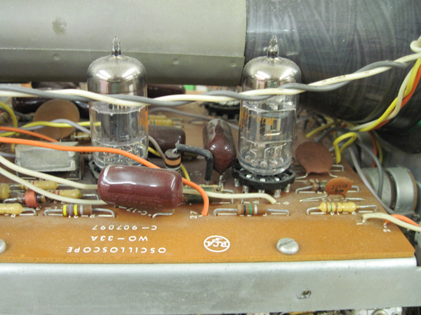 A closeup of two tubes. They are branded RCA. The printed circuit board has the RCA logo and reads "Oscilliscope WO-33A C-907097."